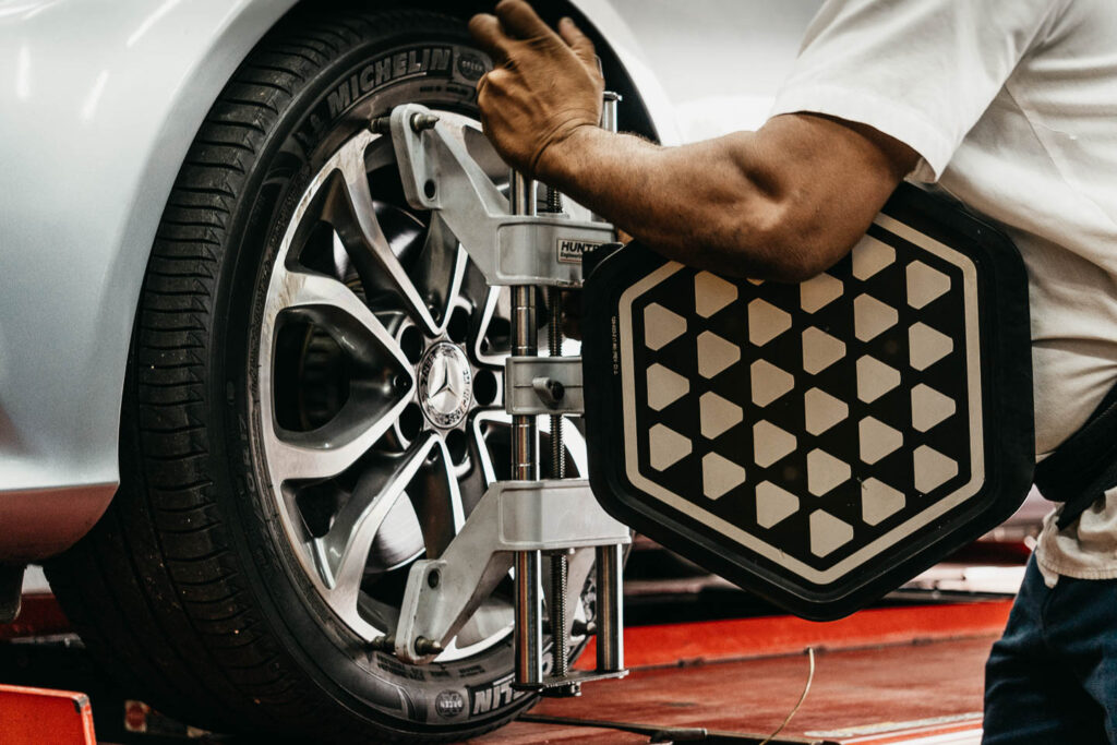 Wheel alignment target clamped to a Mercedes-Benz wheel at Miami Benz, South Miami