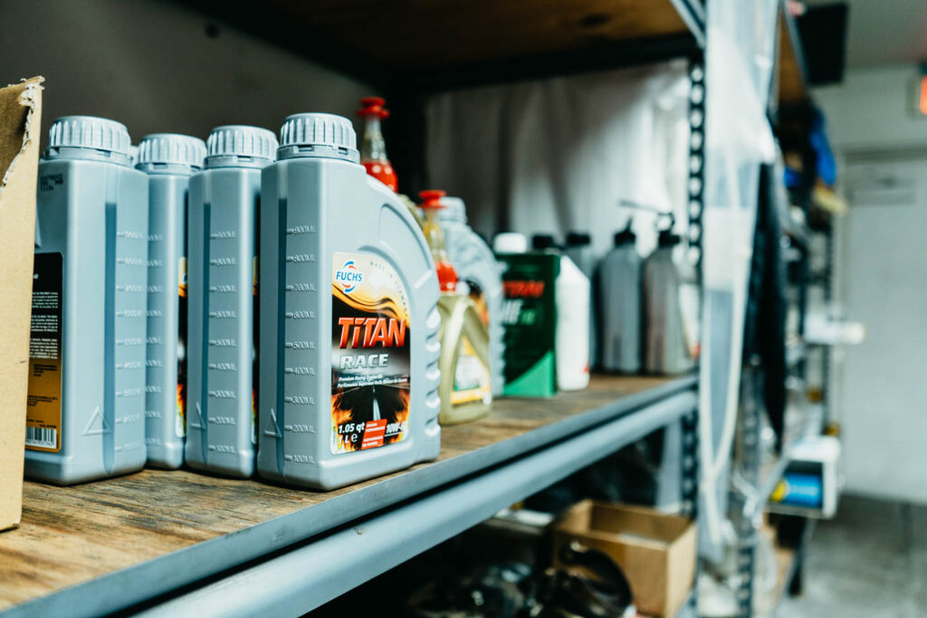Mercedes-Benz OEM engine oils and automotive fluids on shelves at a specialist workshop