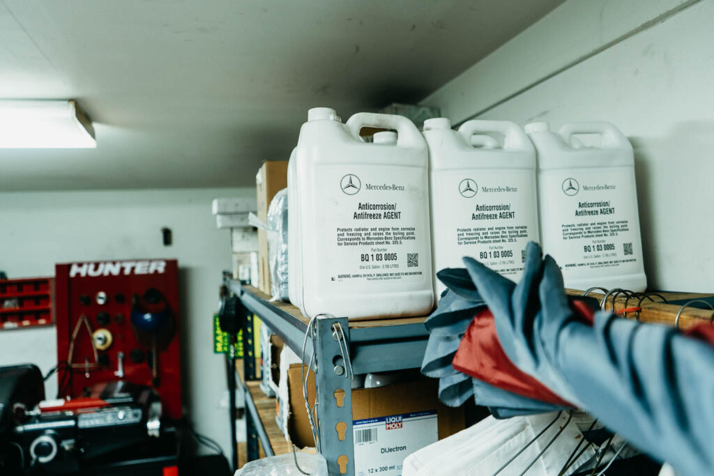 Genuine Mercedes-Benz OEM coolant on the parts shelf at Miami Benz independent workshop in Miami