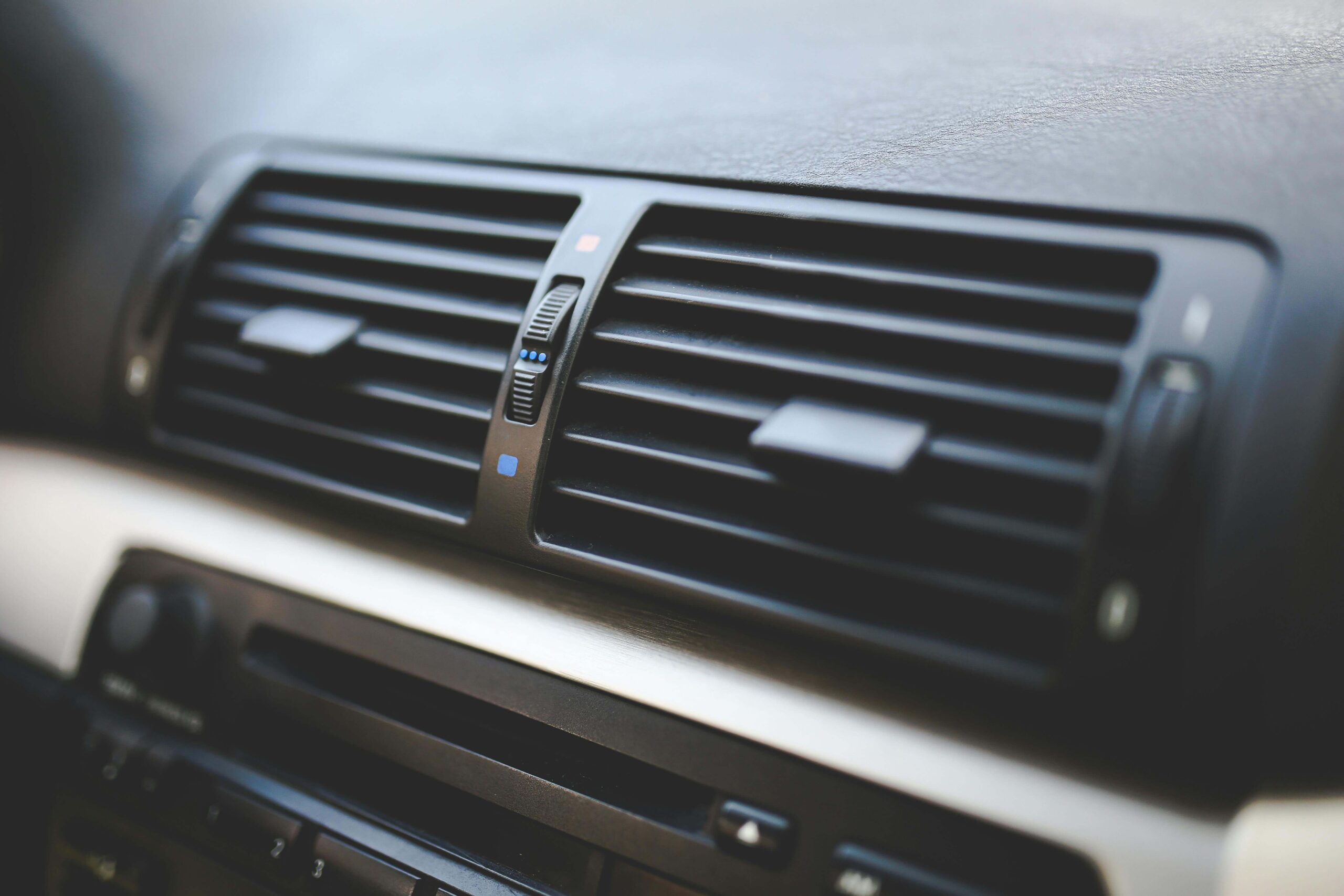 Close-up of a car's air conditioning vent highlighting air conditioning issues.
